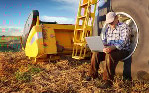 Farmer connecting to the internet on a computer (1)